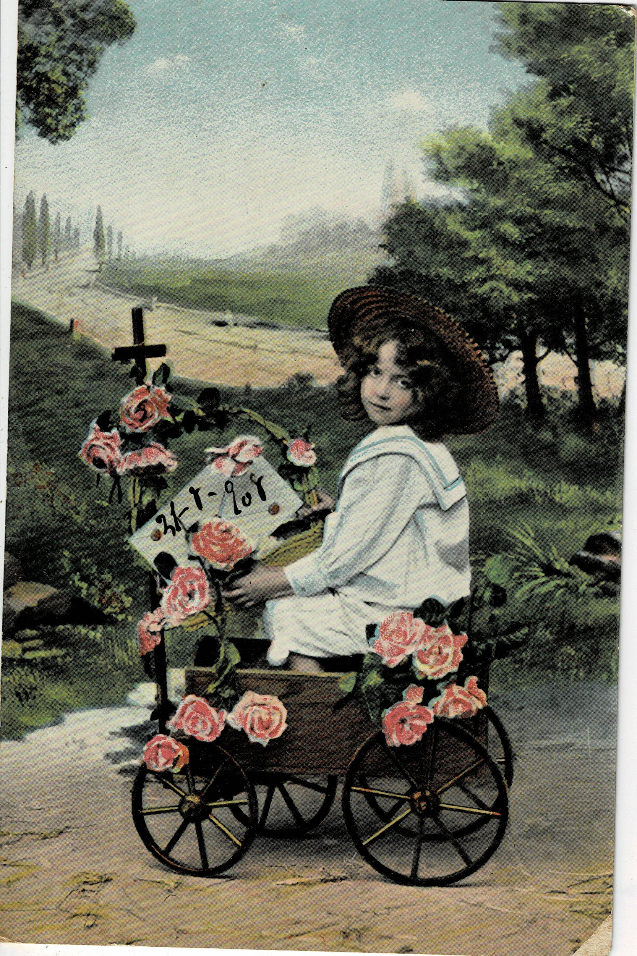 POSTAL NIÑA EN CARRO CON FLORES.