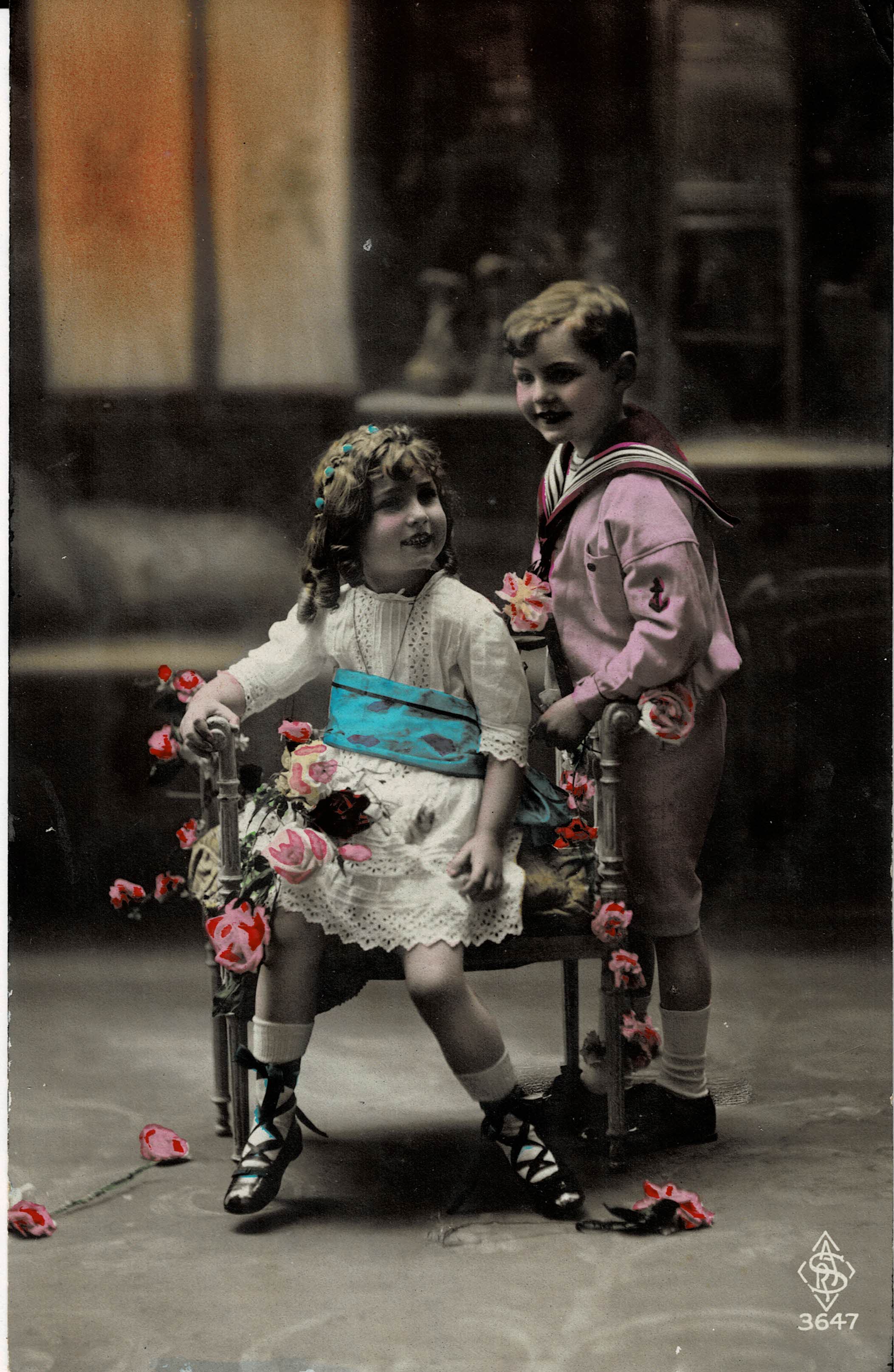 POSTAL NIÑOS EN SILLA CON FLORES.